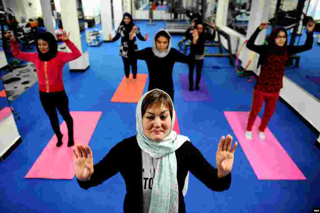 Afghan yoga teacher Fakhria Ibrahimi (front) teaches women at a yoga club in Kabul. The first yoga club, called Blue Moon, has opened in Kabul to provide opportunities for Afghan women to work on their mental and physical health. (epa/Hedayatullah Amid)