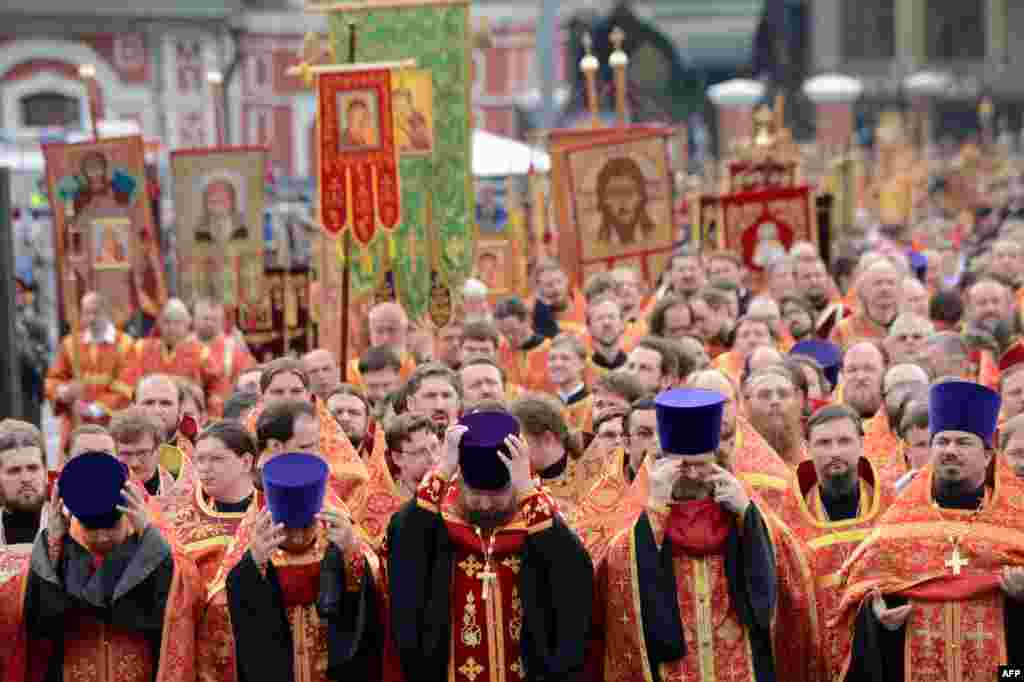 Russian Orthodox priests take part in a religious procession marking Saints Cyrilius and Methodius&#39; Day in central Moscow. The holiday commemorates brothers Cyrilius and Methodius, the creators of the Cyrilic alphabet and symbols of the Slav culture. (AFP/Kirill Kudryavtsev)
