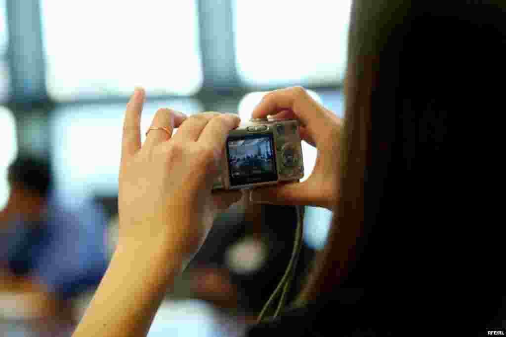 A student takes a photo in the conference room where RFE/RL's daily editorial meetings are held.