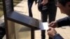 The activists placed their written demands to President Nursultan Nazarbaev in a mailbox in front of the building expressing their opposition to the launch of a Proton-M rocket from the Baikonur space center in Kazakhstan.