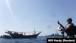 ARABIAN GULF - The Arleigh Burke-class guided-missile destroyer USS McFaul's visit, board, search and seizure team pulls alongside a Bahraini dhow during routine maritime security operations in the Arabian Gulf, June 25, 2019