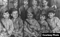 Schoolchildren in the Ukrainian city of Melitopol pose with guns in 1940.