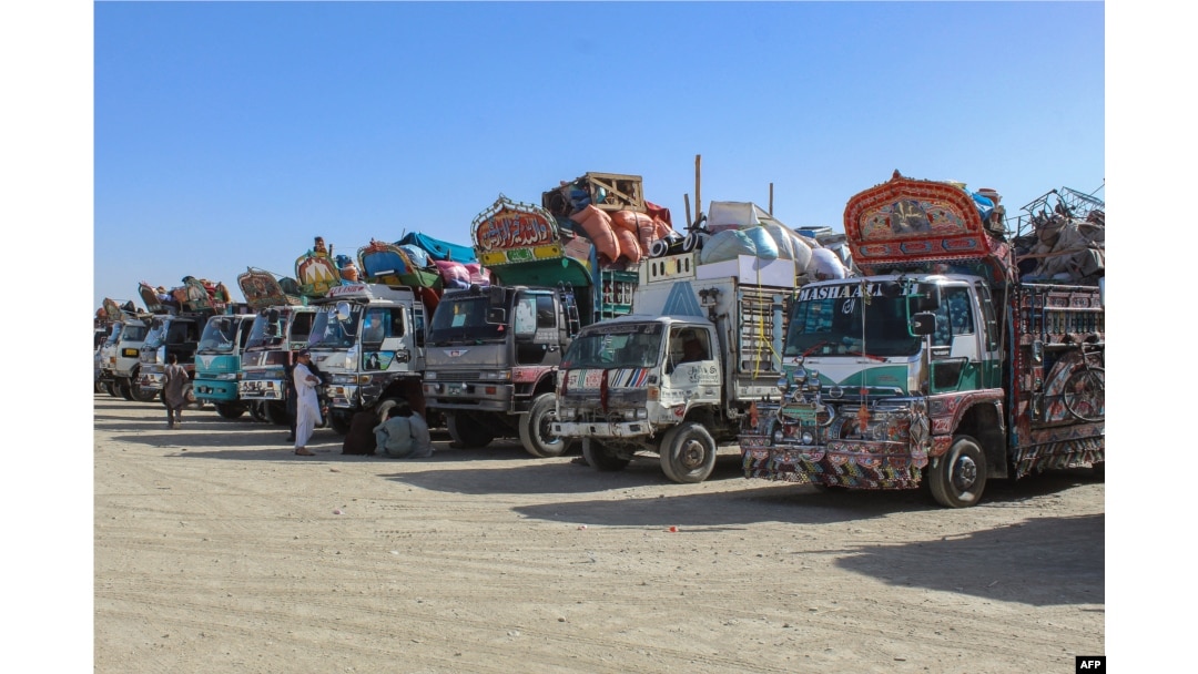 Afghan refugees wait beside trucks loaded with their belongings before departing to Afghanistan at a holding center near the border in Chaman, Pakistan, on April 27. Afghan refugees wait beside trucks loaded with their belongings before departing to Afghanistan at a holding center near the border in Chaman, Pakistan, on April 27.