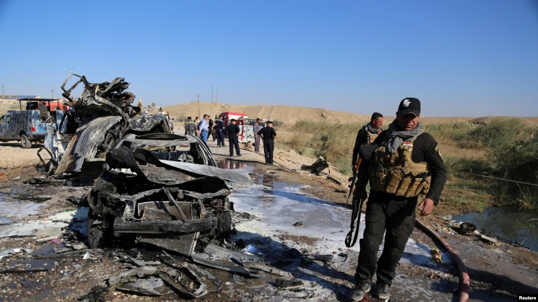 Iraqi security forces inspect the site of a deadly bomb attack in Tikrit on November 6. 