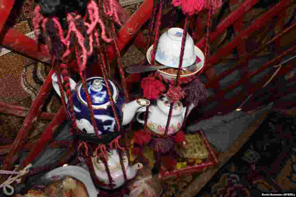 Dishes, teapots, and other items are kept suspended inside the yurt.