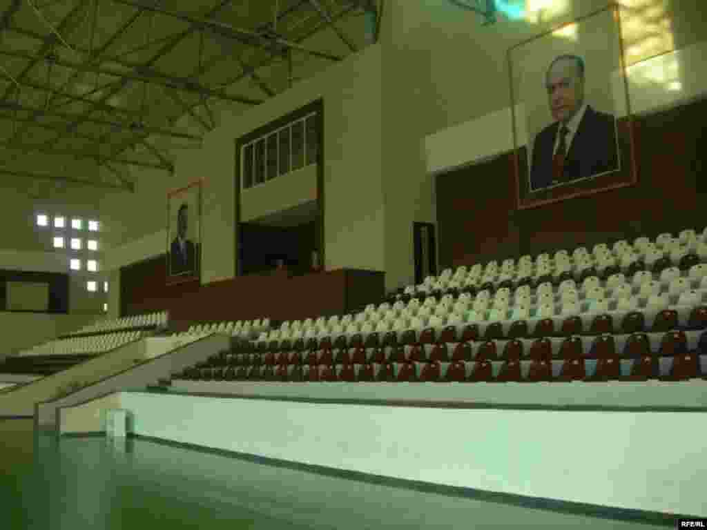 Portraits of President Ilham Aliyev, who previously headed Azerbaijan's Olympic Committee, and his late father, Heidar Aliyev, watch over an empty gym - The swimming pool at the Masalli sports center remains dry -- and locals say the complex has just one regular visitor. Meanwhile, its upkeep and maintenance cost some $10,000 each month.