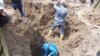 Rescue workers search for victims of a landslide that killed at least 24 people in southern Kyrgyzstan on April 29. 