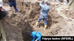 Rescue workers search for victims of a landslide that killed at least 24 people in southern Kyrgyzstan on April 29. 