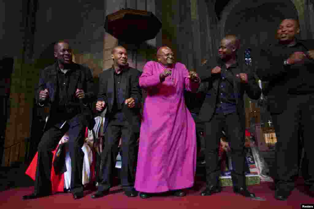 South African Archbishop Emeritus Desmond Tutu (center) dances with the Cape Town Opera Ensemble at the Templeton Prize celebration at St. George’s Cathedral in Cape Town. Tutu won the 2013 Templeton Prize, worth $1.7 million, for helping inspire people around the world by promoting forgiveness and justice. (Reuters/Ilan Godfrey)