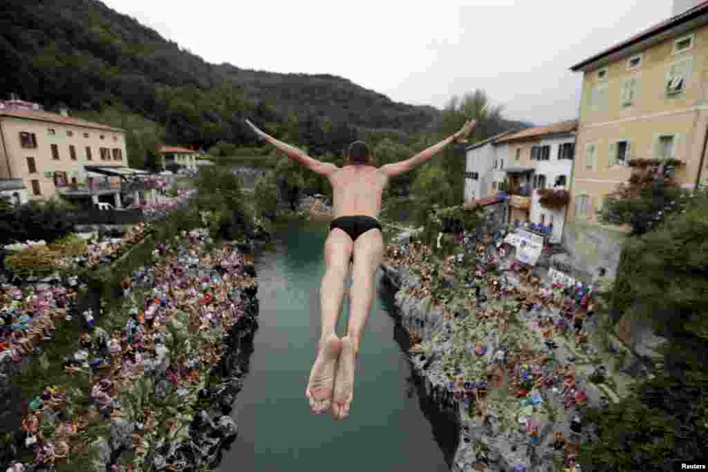 A competitor jumps from the old bridge during a cliff-diving competition in Kanal ob Soci in southwestern Slovenia. (Reuters/Srdjan Zivulovic)