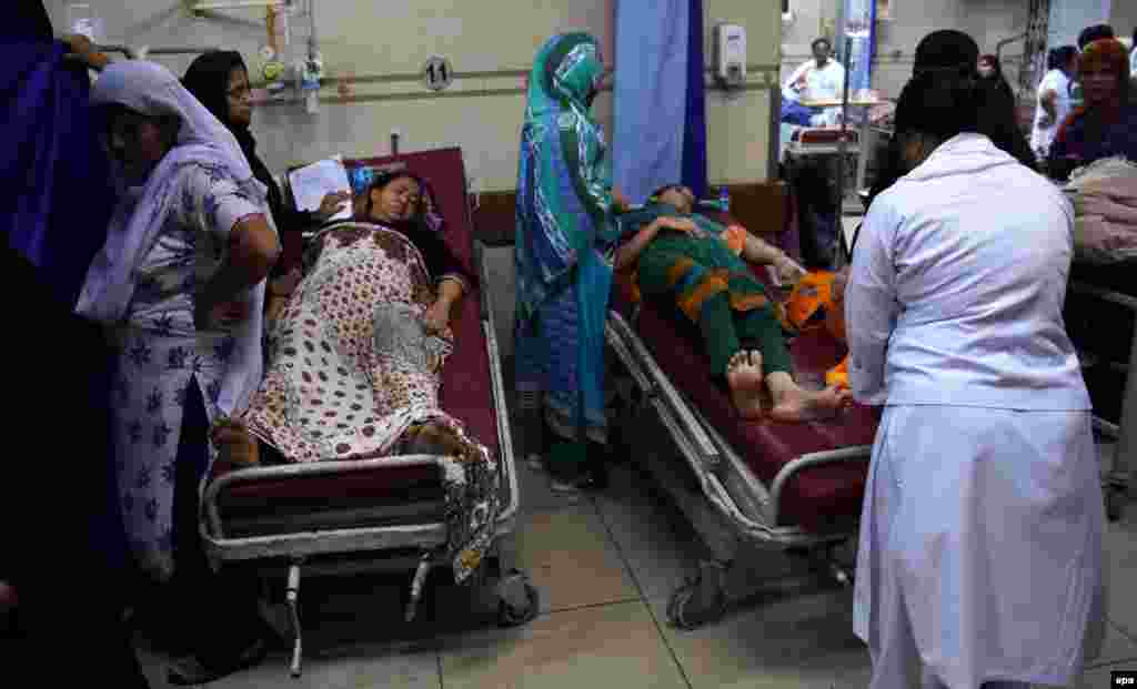 People receive medical treatment at a hospital in Karachi.