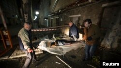 Ukraine -- People carry the body of a victim killed by recent shelling near the Red Cross office in Donetsk, October 2, 2014