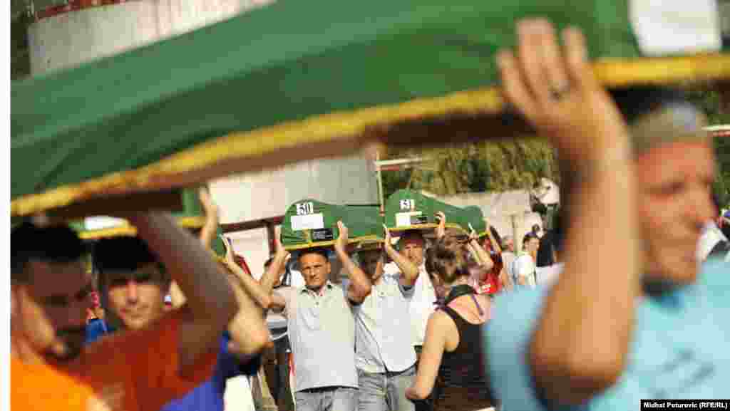 The caskets with the remains of Srebrenica victims are prepared on July 11 for the mass burial the next day at the Memorial Center in Potocari, near Srebrenica.