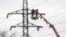 Workers restore a high-voltage line destroyed in a Russian missile attack in Kyiv. (file photo)