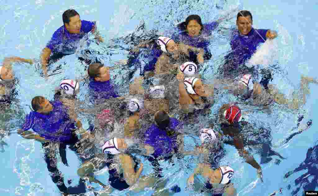 Members of the U.S. team react after winning the gold medal in women&#39;s water polo.