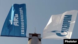 The flags of the ARG national gas operator and its dominant Russian shareholder, Gazprom (file photo)