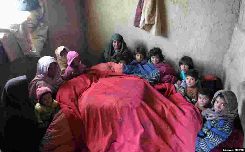 Afghanistan-Kabul International Children's Day 2012: Afghan children sit at their shelter in Kabul, may,31,2102.