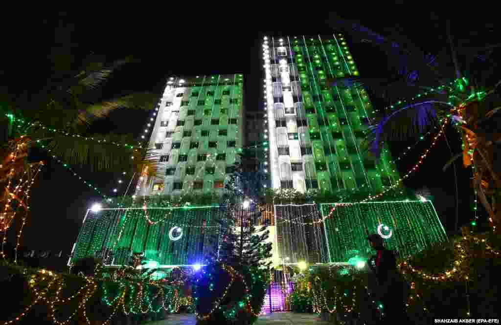 A Karachi building is illuminated in green, the main color of the Pakistani flag.