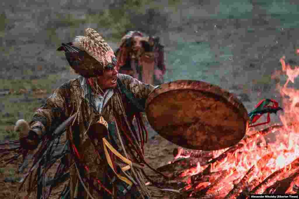 A shaman hammers his drum during a ritual in Russia's Tuva Republic, in southern Siberia. During ceremonies like this, the beat of the drum grows steadily faster as the shamans circle a fire. While the beat intensifies, unearthly screams come from the shaman. At the height of the ritual the soul of the shaman is said to leave his or her body in order to make room for a spirit to enter. 