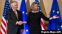 U.S. Secretary of State Rex Tillerson (left) meets with EU foreign policy chief Federica Mogherini in Brussels on December 5.