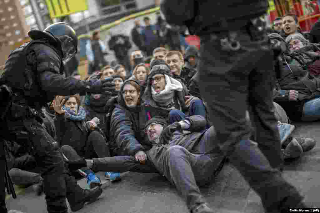 Catalan police officers remove demonstrators blocking a road leading to Barcelona city during a general strike in Catalonia, Spain. Strikers advocating for Catalonia's secession from Spain are blocking major highways, train lines, and roads across the northeastern region. (AP/Emilio Morenatti)