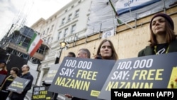 U.K. -- Campaigners hold posters as Richard Ratcliffe, husband of jailed British-Iranian woman Nazanin Zaghari-Ratcliffe, delivers a petition and a letter addressed to the Iranian Deputy Foreign Minister Abbas Araghchi to demand her release, at the Irania