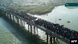 Islamic Republic of Iran News Network state TV on January 3 shows pro-government demonstrators in the streets of the southwestern Iranian city of Ahvaz.