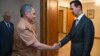 A file photo of Russian Defense Minister Sergei Shoigu (left) shaking hands with Syrian President Bashar al-Assad during a meeting in Damascus in 2016. 