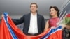 Russia -- Russian opera singer Anna Netrebko (R) and Chairman of the Parliament of so-called Neo-Russia (self-proclaimed Donetsk and Luhansk republics), Oleg Tzarev posie with a flag of Neo-Russia in St. Petersburg, December 8, 2014