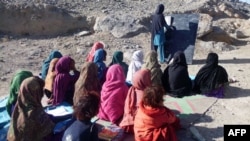 Schoolgirls study at an outdoor classroom in the rural district of Laghman Province in November 2012. (file photo)