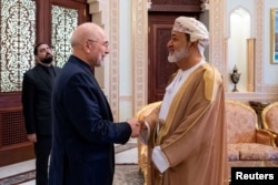 Sultan of Oman Haitham bin Tariq Al Said (right) shakes hands with Iranian parliament speaker Mohammad Baqer Qalibaf in Muscat on June 23.