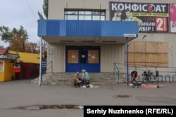 Women sell flowers and agricultural products from their own plot of land, near a closed supermarket in the city of Pokrovsk, which the Russian Army is trying to capture and is now 8-10 kilometers away from.