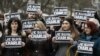 Spain -- Spanish journalists hold posters reading 'Je suis Charlie' (I am Charlie) to show their solidarity with the victims of the massacre at the headquarters of French satirical magazine Charlie Hebdo in Paris during a minute of silence in Pamplona, no