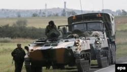 Russia -- Russian military vehicles and servicemen in a field outside the town of Kamensk-Shakhtinsky in Rostov region, about 30 kms from the Russian-Ukrainian border, August 18, 2014