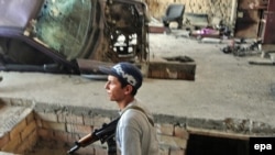 A police serviceman searching a house in an ethnic Uzbek district of Osh during the June violence in Kyrgyzstan.