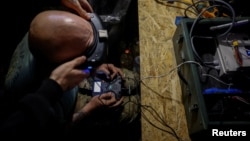 Ukrainian service members operate an FPV drones during the unilaterally proposed three-day ceasefire declared by Russia, near a frontline in Dnipropetrovsk region