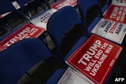 A sign reading "Trump Will End the Ukraine War" is set on attendees' chairs during the third day of the 2024 Republican National Convention in Milwaukee, Wisconsin, on July 17.