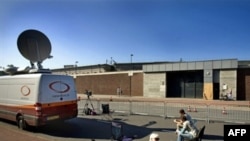 Journalists wait outside Scheveningen prison in The Hague, where it is expected Karadzic will be held after his extradition.