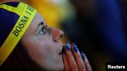 A Bosnian soccer fan reacts after Argentina scores a goal during the 2014 World Cup soccer match. 