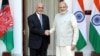 Afghan President Ashraf Ghani and Indian Prime Minister Narendra Modi shake hands on February 9 after signing an agreement to build the Shah Toot on the Kabul River.