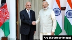 Afghan President Ashraf Ghani and Indian Prime Minister Narendra Modi shake hands on February 9 after signing an agreement to build the Shah Toot on the Kabul River.