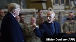 Afghan President Ashraf Ghani (right) addresses U.S. troops during Trump's surprise Thanksgiving visit at Bagram on November 28, 2019.