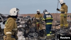 Kazakh emergency specialists work at the crash site of a passenger plane near Aqtau on December 25. 