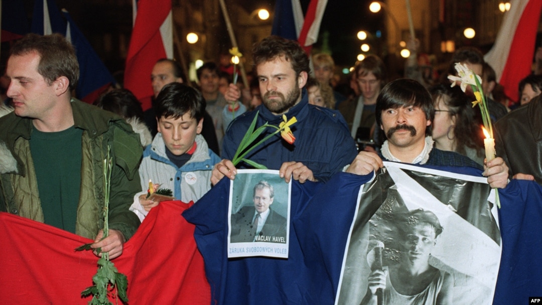 Czechoslovak students holding a picture of Vaclav Havel and poster reading "The Truth Will Win" march in support of Havel for president in December 1989 in Prague.