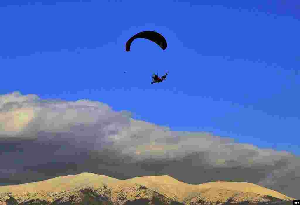 An unusual sight in the skies of Blagoevgrad, Bulgaria, as a pilot dressed as Santa Claus comes in on a paramotorized sled. (epa/Emil Mihaylov)