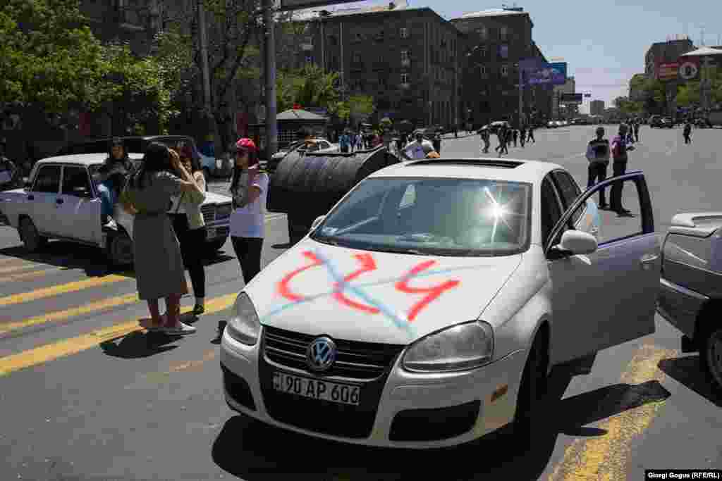 The name of Armenia&#39;s ruling Republican Party (HHK) crossed out on the hood of a protester&#39;s car in Yerevan. Opposition leader Nikol Pashinian said the HHK&#39;s parliamentary faction had &quot;destroyed itself irreversibly&quot; and announced &quot;war against its own people&quot; by refusing to support his candidacy for prime minister.