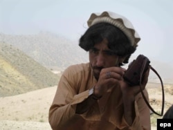 A tribesman listens to news on a radio after the Pakistani military launched a full-scale offensive against the Tehrik-e Taliban in North Waziristan in June 2014.