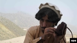 FILE: A picture made available on 20 June 2014 shows a local tribesman listening to news on a radio after Pakistani military launched an offensive in North Waziristan.