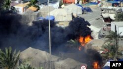 Black smoke billows on Pearl Square in Manama on March 16.