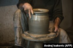 A Zlakusa potter works a piece into shape on a hand-turned wheel.